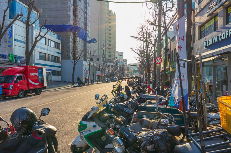 Korea - HK - China - KORKONG! - Its a street full of motorbikes and blazing sunshine. Actually its a street full of factories making paper and paper related products. Forklifts const
