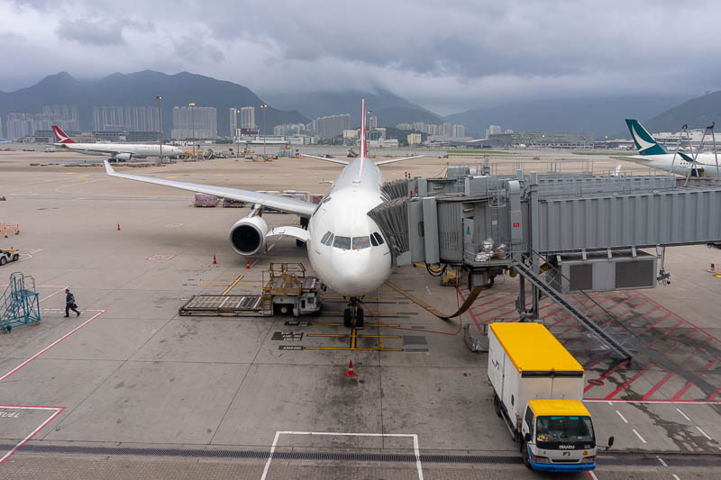 Korea - HK - China - KORKONG! - That is not my plane. It is a Qantas jet, but I took the photo because of those mountains, calling me, shrouded in cloud currently. I will be back in 
