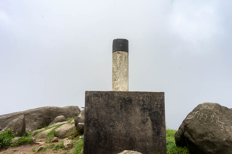 Hong Kong-Hiking-Sunset Peak - Here is the summit marker thing the young couple climbed to stand on the top of together for a photo. Foolish. I described the bum exposing pants rela