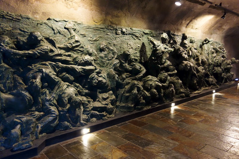 China-Chongqing-Monorail-Museum - A wall sculpture depicting the horrors inflicted by Japan.