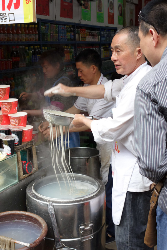 China-Chongqing-Ciqikou-Temple - Heres a different kind of noodle. Put this grey goop in a sieve with a few holes in it, beat the liquid with your palm to force it through into waitin