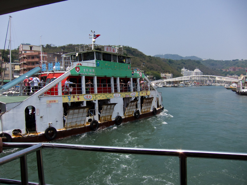 Taiwan / Hong Kong / Singapore - March/April 2011 - Heres a similar ferry going the other way, note the gang plank things, the ferry was pretty overcrowded. They have a tv showing how to put on a life j