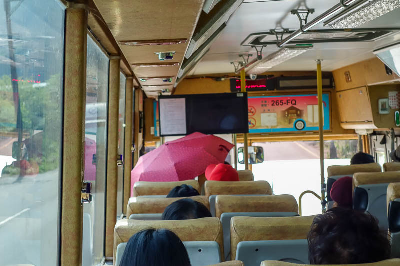 Taiwan-Jiufen-Hiking-Teapot Mountain - Boring photo from inside the bus to Jiufen, or is it? Note the woman up the front has put her umbrella up, inside the bus. Another new way to terrify 