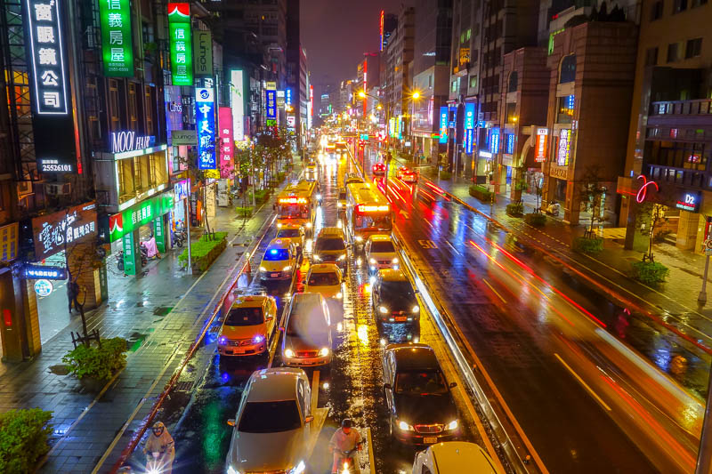 A full lap of Taiwan in March 2017 - And heres some proof that I am a lunatic. I climbed up onto the overpass to take a photo of traffic in the rain. Nice reflections. The people below as