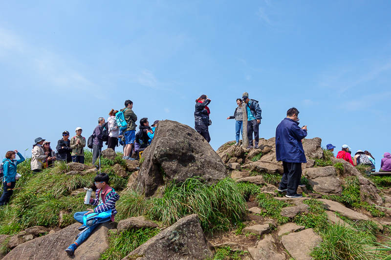 Taiwan-Taipei-Hiking-Yangmingshan - That is a line to have your photo taken with the peak marker. Last time I was here old folks tried to make me eat little tomatoes to help with altitud