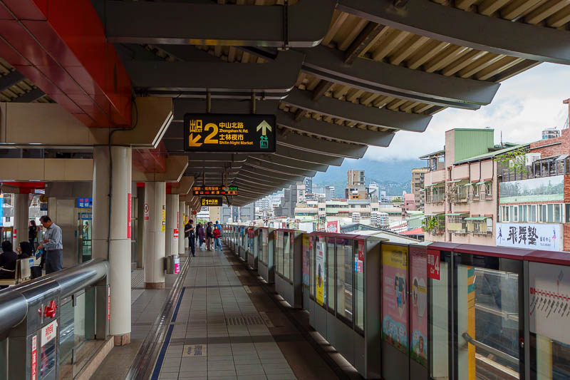 Taiwan for the 5th time - April and May 2023 - The subway here is above ground, like the Melbourne sky rail. You can get a great view, that is Yangminshan in the distance covered in cloud, possible