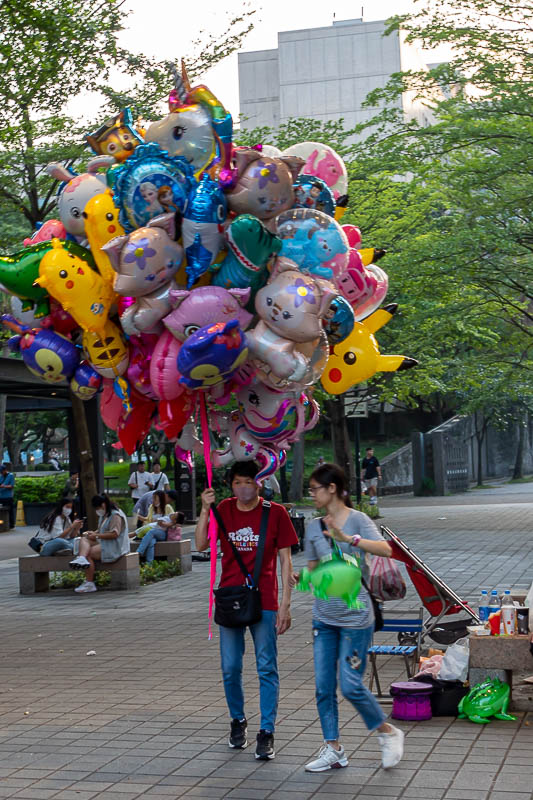 Taiwan-Taipei-Xinyi-Food - This guy is trying to avoid the fee to go up to the top of Taipei 101. But seriously, sadly selling these metal balloons to kids to let go so they flo